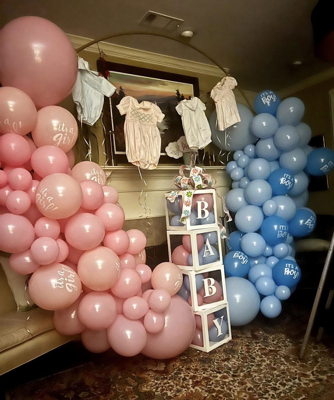 Pink and blue gender reveal balloon arch with BABY boxes