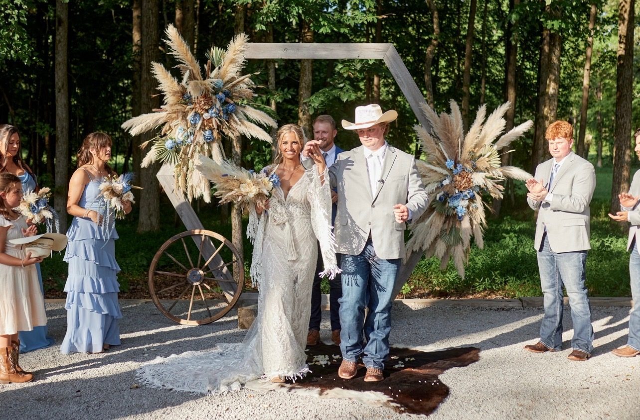 Boho wedding ceremony arch with pampas grass and blue florals